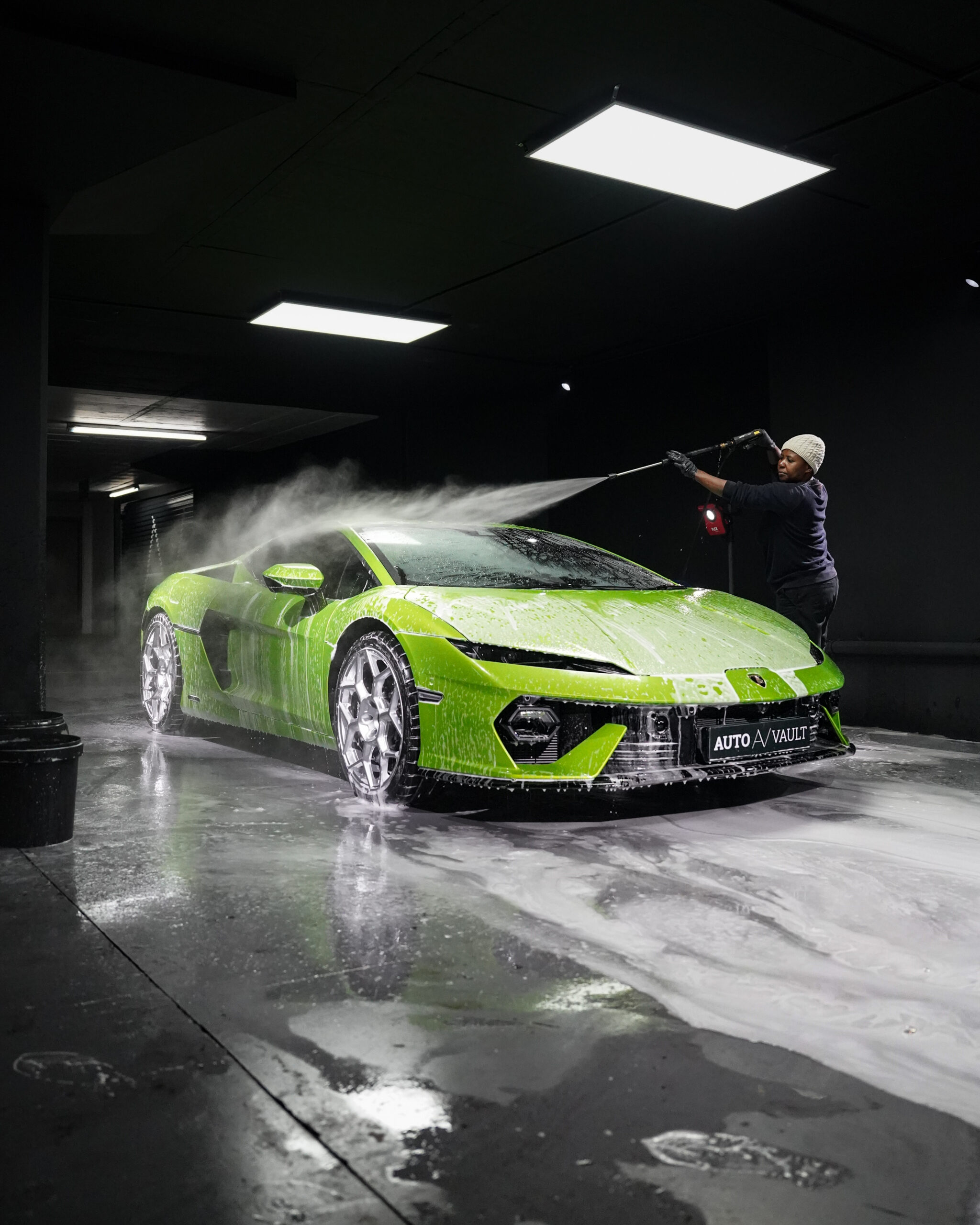 A Lamborghini Temerario being washed in the Auto Vault bay, buckets ready